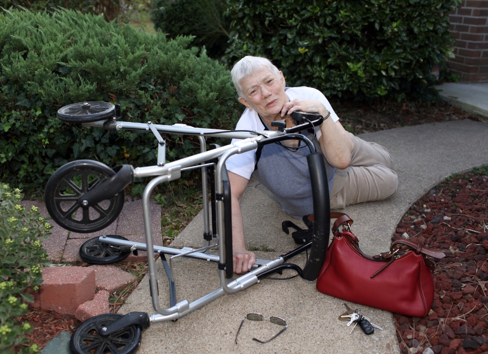 Woman with walker fallen on concrete path canva 665x443