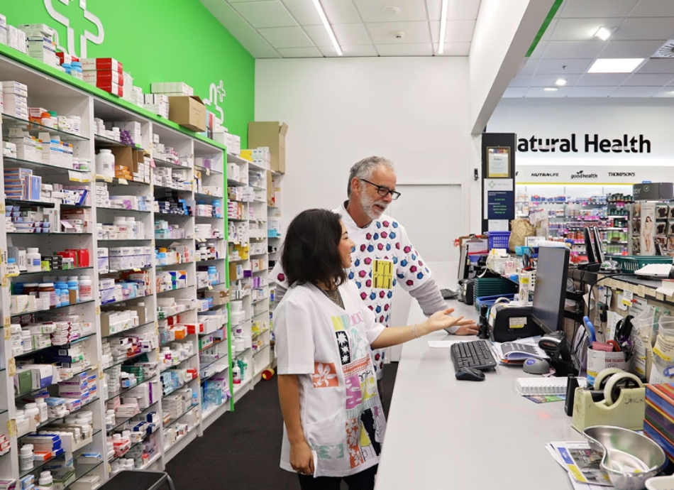 HN 0796 two pharmacists in discussion in dispensary of community pharmacy  950x690