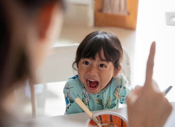 Angry child shouting at mother