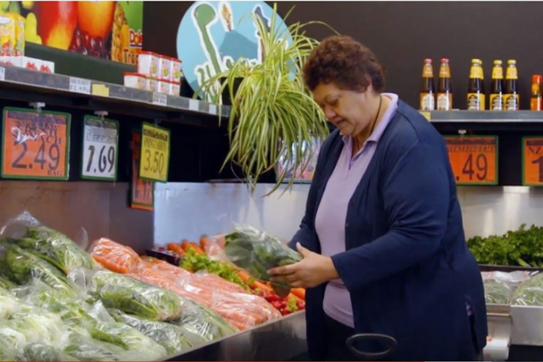 Woman choosing vegetables in supermarket