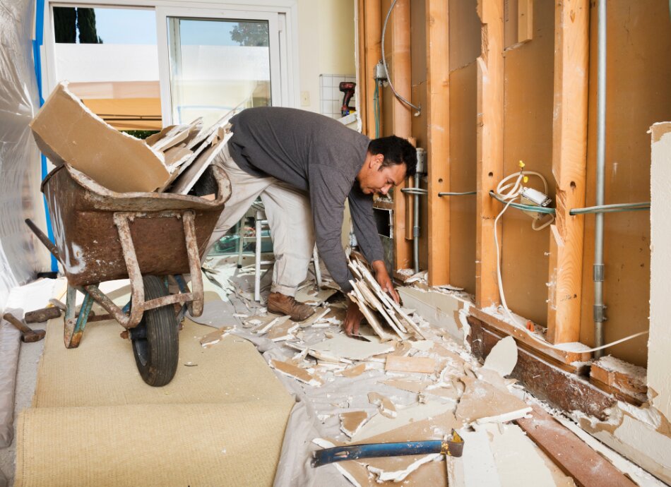 Man renovating walls inside house