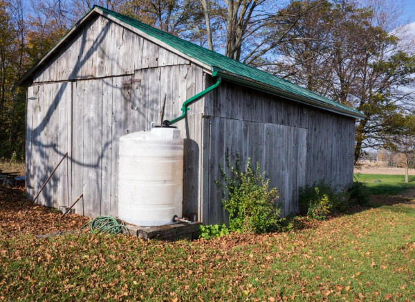 Rain water collecting from shed roof to storage tank