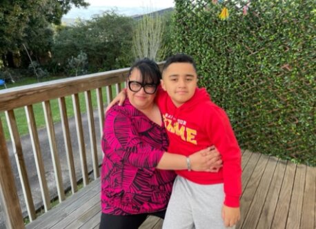 Pasifika mother and son outside on their deck
