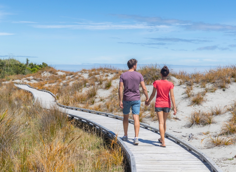 Couple hand in hand on NZ beach