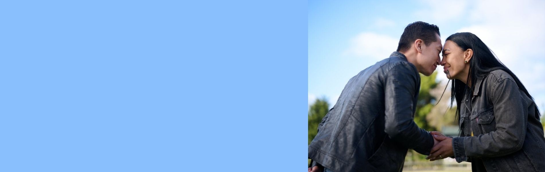 Two people hongi as they meet slider